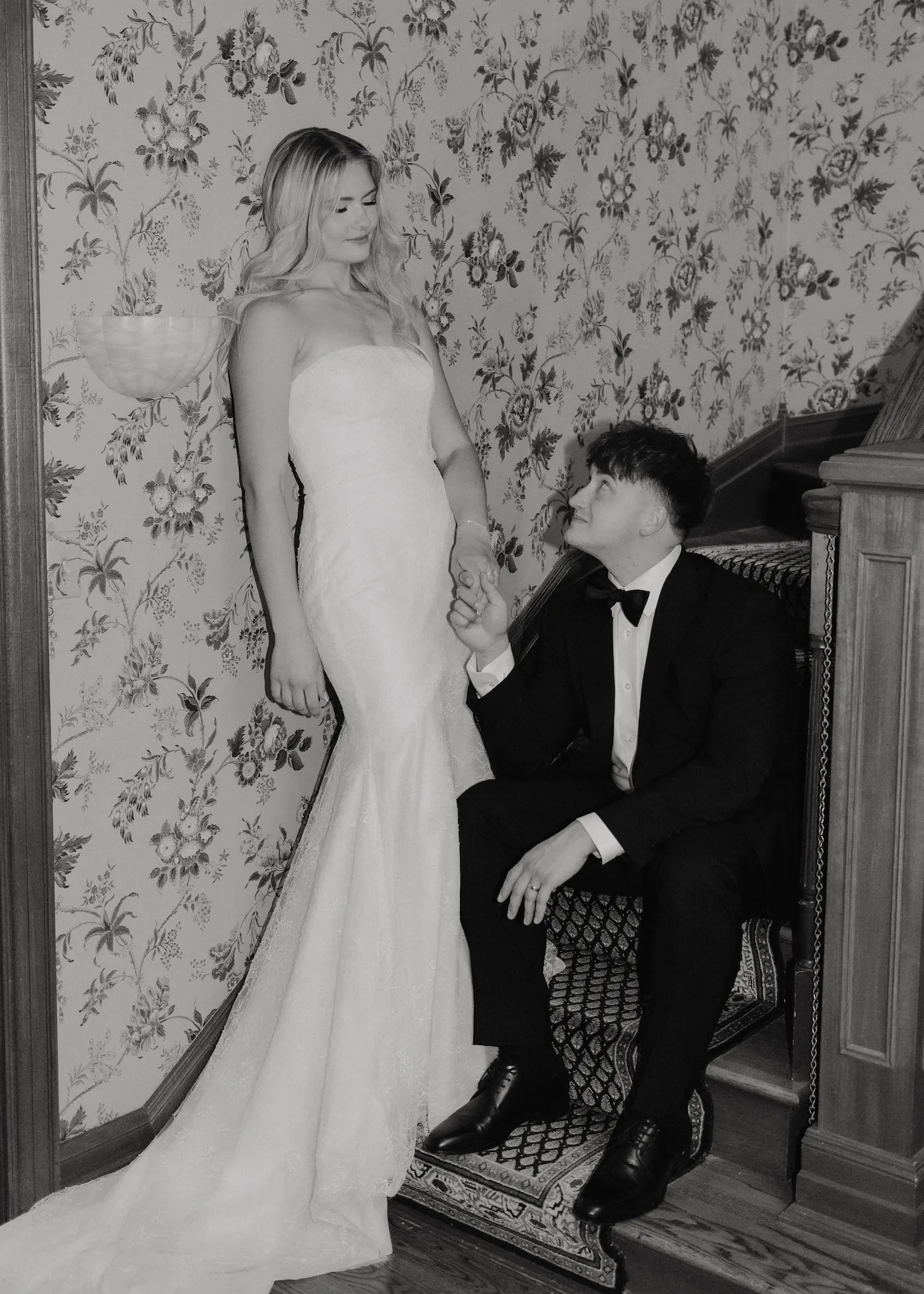 Wedding portrait of a bride and groom on a staircase in black and white